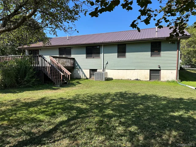 a view of backyard of house with green space