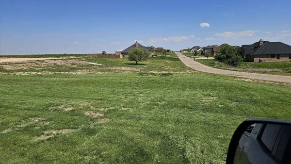 a view of a field with an ocean