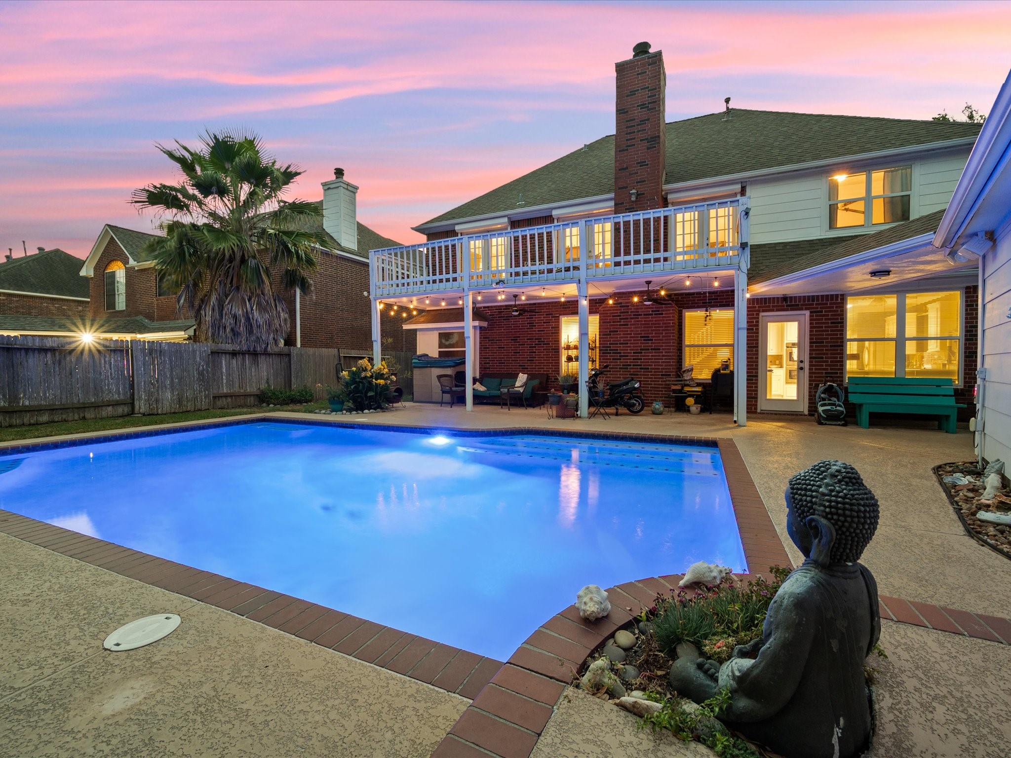 a front view of a house with swimming pool and a yard