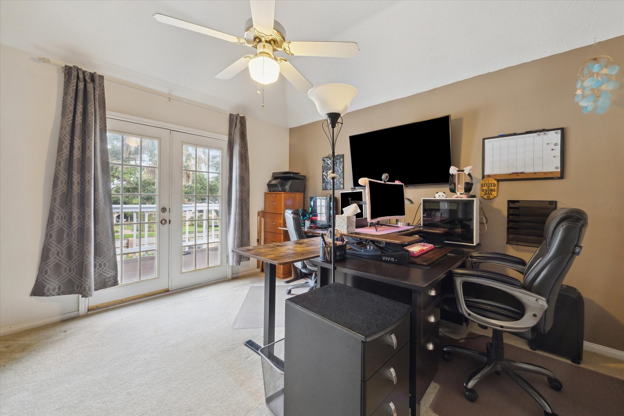 2326 Pin Hook Court Seabrook, TX 77586 - Photo 23 of 42 a work room with furniture a flat screen tv and a large window