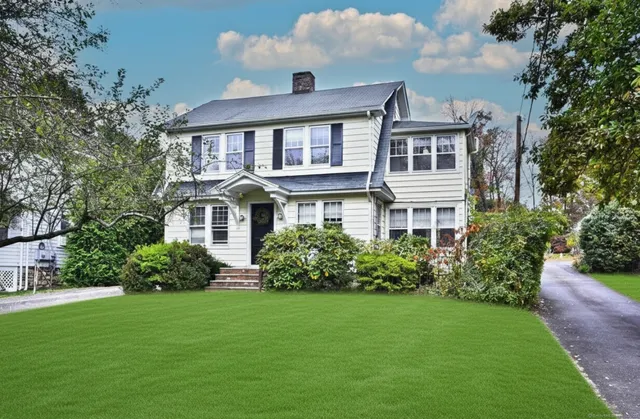 a front view of a house with a yard