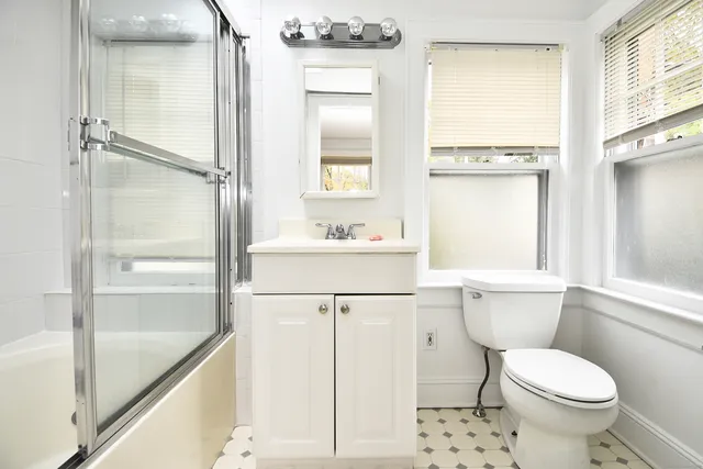 a bathroom with a toilet a sink and a shower