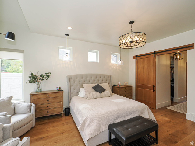 3167 South Mapleton Estates Drive Mapleton, UT 84664 - Photo 12 of 42 Bedroom featuring a barn door, wood finished floors, and recessed lighting