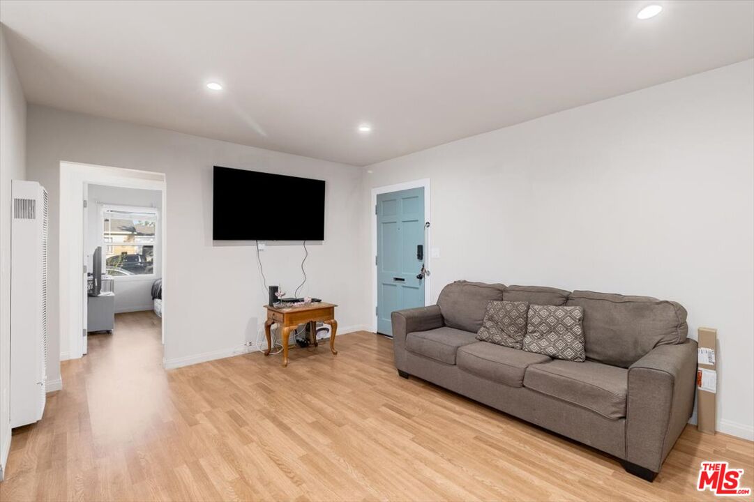 1206 West Magnolia Street Compton, CA 90220 - Photo 13 of 40 a living room with furniture and a flat screen tv
