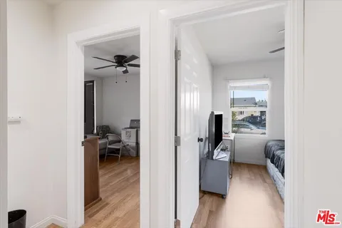 a view of a hallway with couch and closet