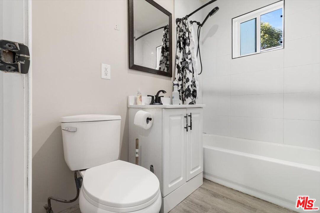 1206 West Magnolia Street Compton, CA 90220 - Photo 17 of 40 a white toilet sitting next to a bath tub