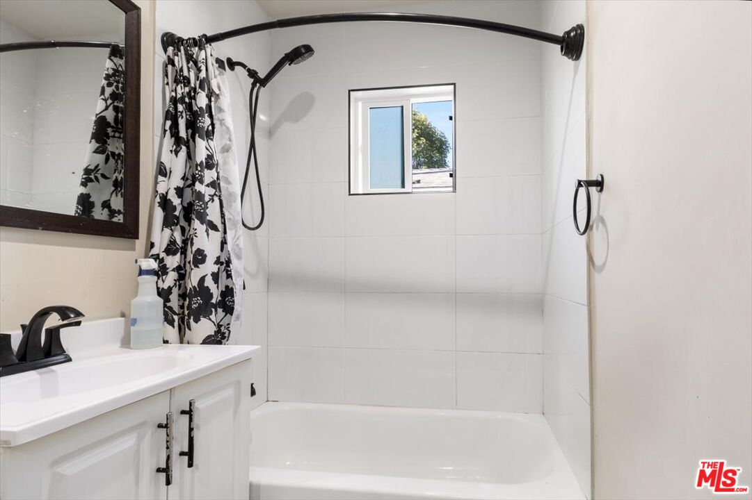 1206 West Magnolia Street Compton, CA 90220 - Photo 18 of 40 a bathroom with a bathtub and shower