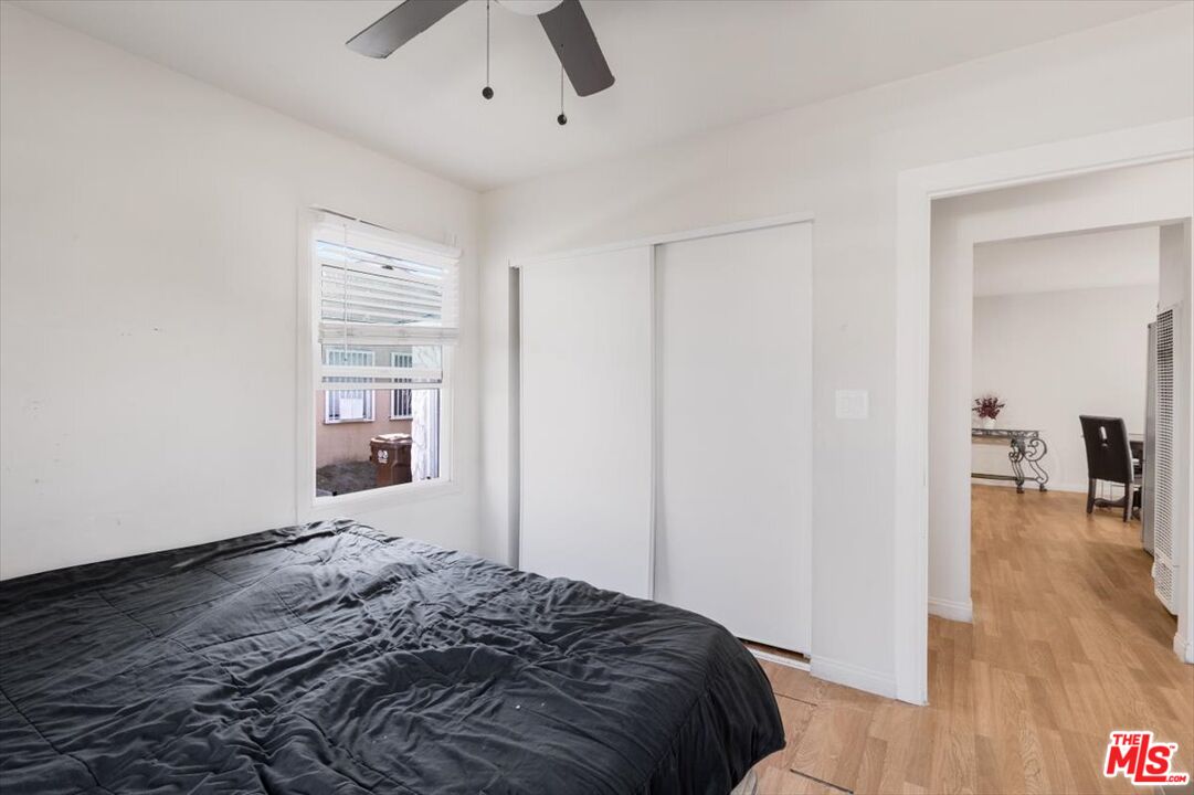 1206 West Magnolia Street Compton, CA 90220 - Photo 23 of 40 a bedroom with a bed and a view of livingroom