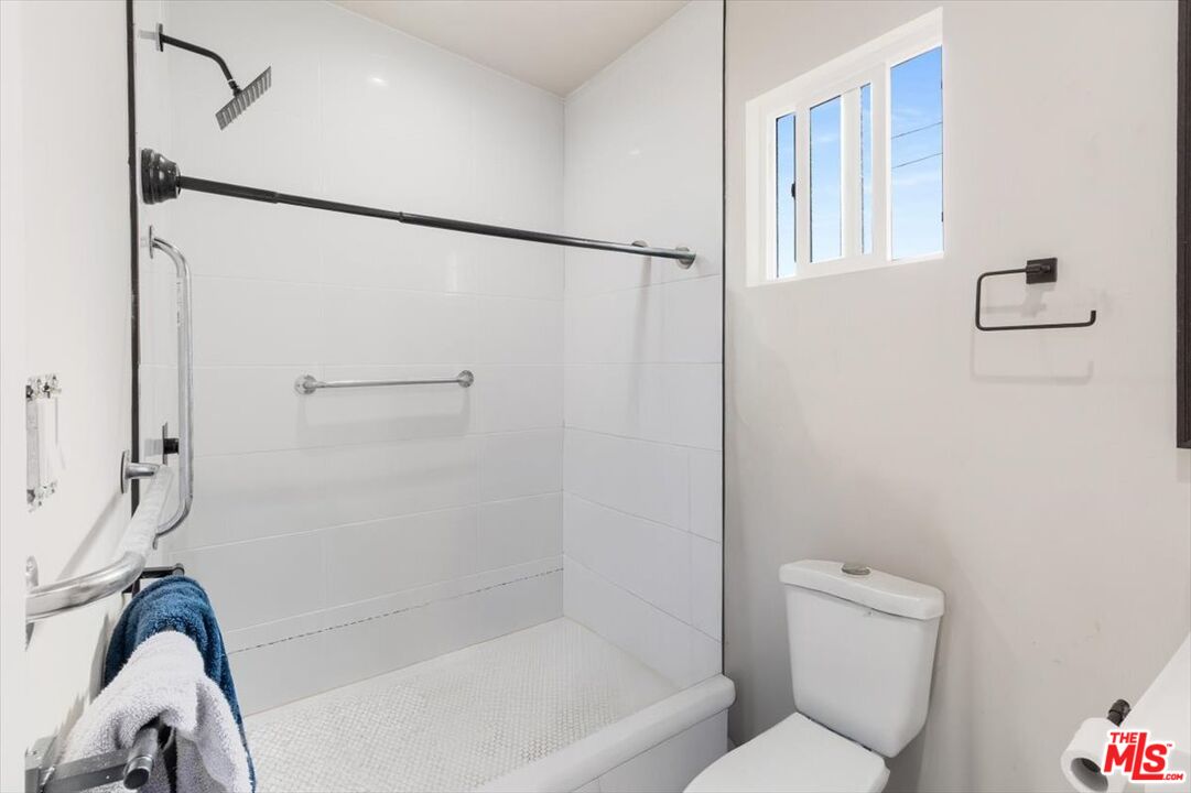 1206 West Magnolia Street Compton, CA 90220 - Photo 30 of 40 a bathroom with a toilet and a shower