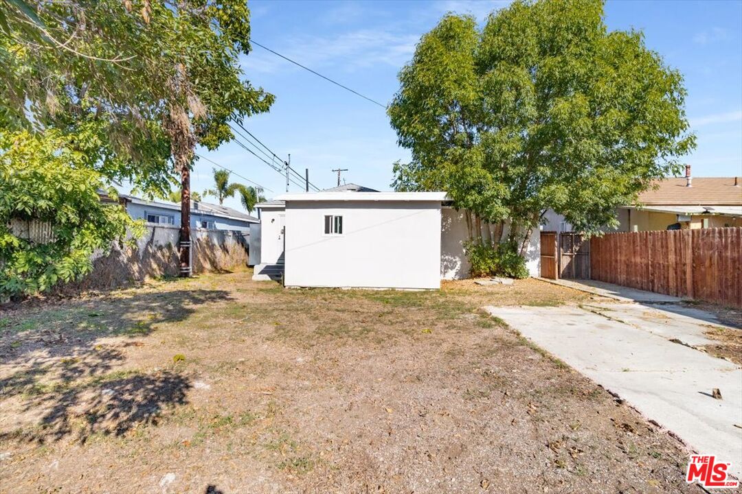 1206 West Magnolia Street Compton, CA 90220 - Photo 35 of 40 a view of a house with a yard and garage