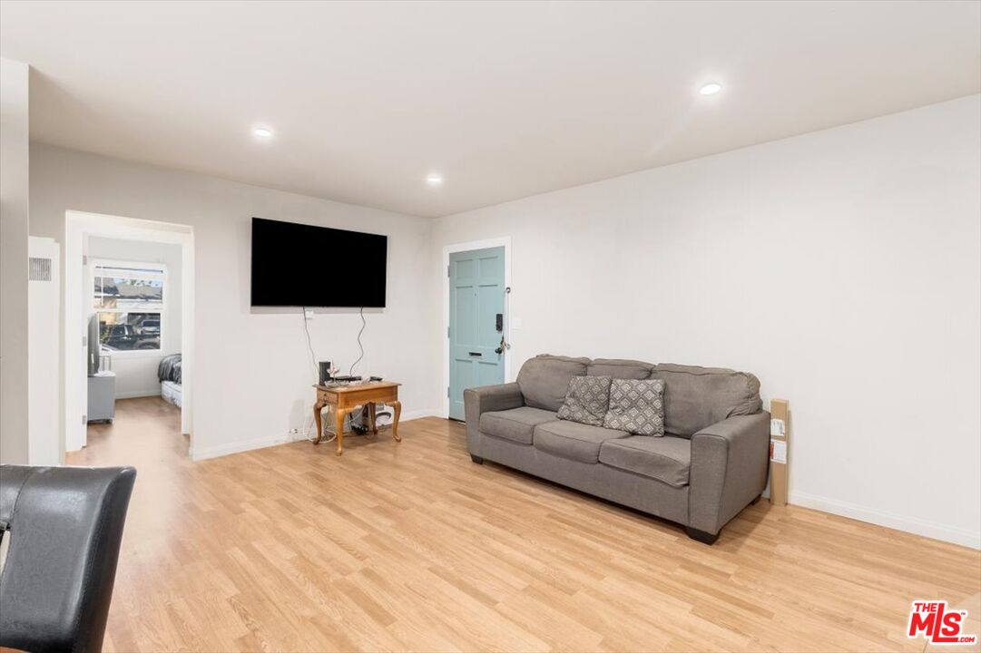 1206 West Magnolia Street Compton, CA 90220 - Photo 6 of 40 a living room with furniture and a flat screen tv