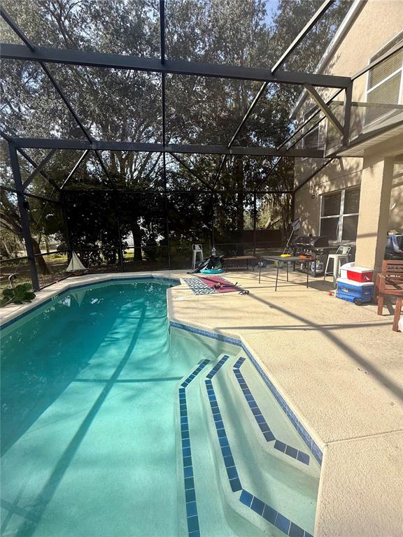 1008 Royal Ridge Drive Davenport, FL 33896 - Photo 18 of 19 a view of a swimming pool with a patio and a yard