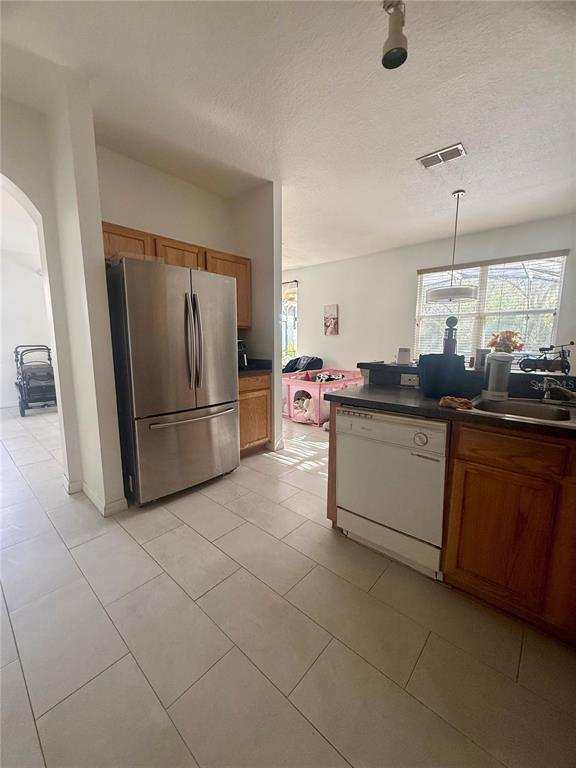 1008 Royal Ridge Drive Davenport, FL 33896 - Photo 7 of 19 a kitchen with stainless steel appliances granite countertop a sink and a refrigerator