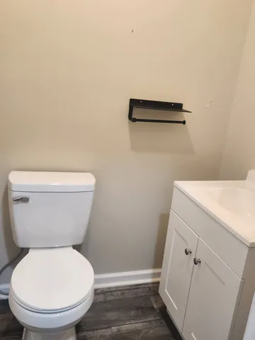 a white toilet sitting next to a shower