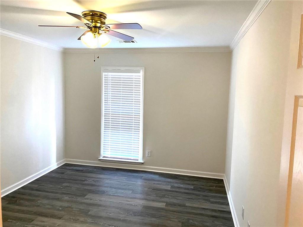 1166 Booth Road Southwest, Unit 610 Marietta, GA 30008 - Photo 10 of 20 a view of an empty room with wooden floor and a window