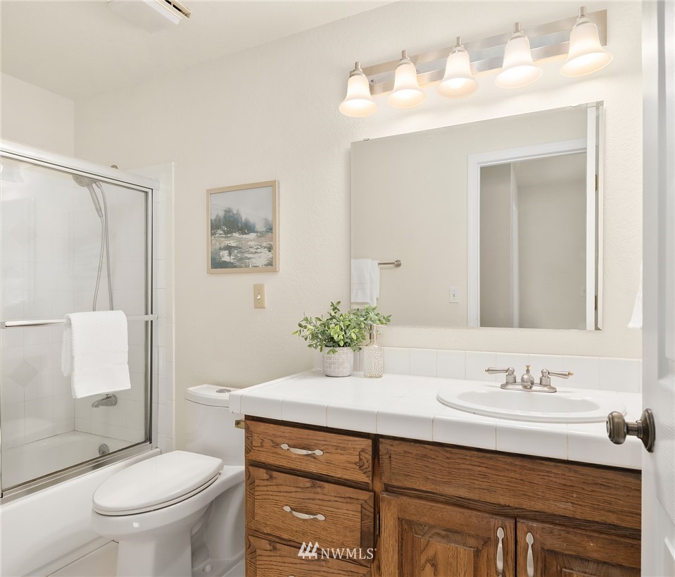 17545 Southeast 136th Street Renton, WA 98059 - Photo 22 of 39 a bathroom with a sink vanity mirror and toilet