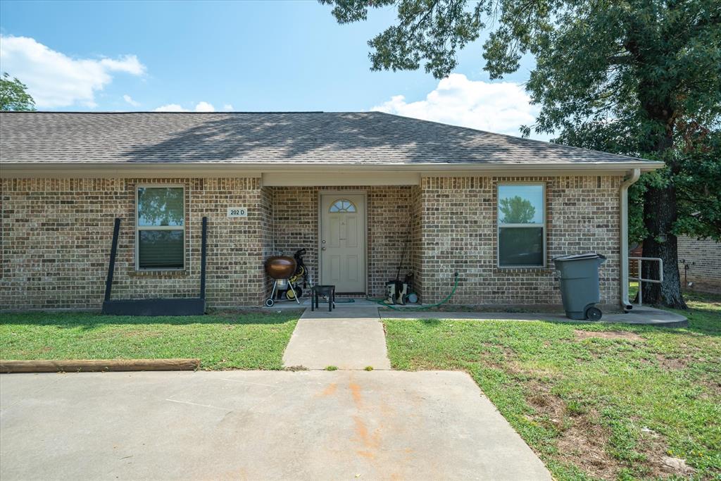 202 Chestnut Drive Van, TX 75790 - Photo 12 of 12 View of front of house featuring a front yard, roof with shingles, and brick siding