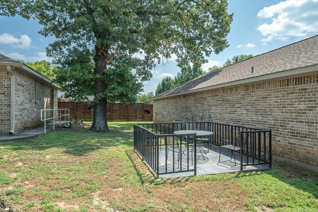 202 Chestnut Drive Van, TX 75790 - Photo 9 of 12 Fenced backyard featuring a patio area