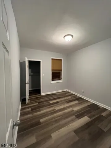 a view of a livingroom with wooden floor and a ceiling fan