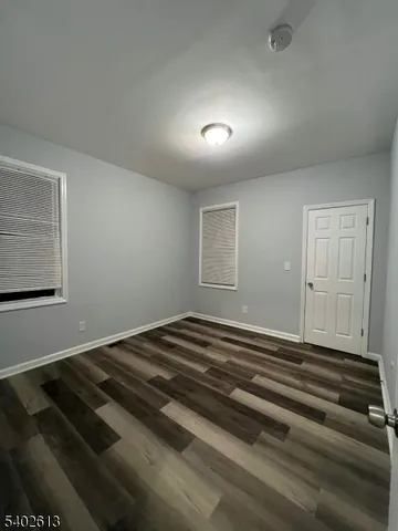 a view of a livingroom with wooden floor and a window