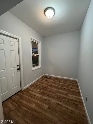 a view of a room with wooden floor and bedroom