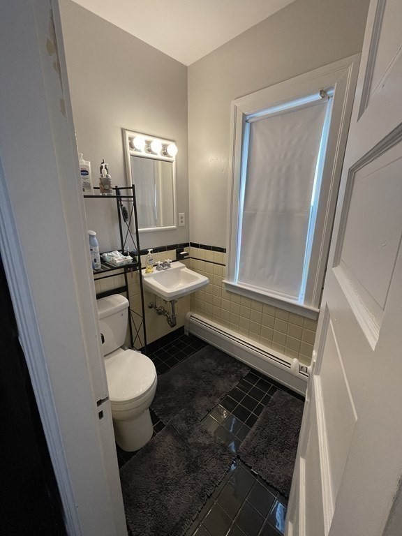 9 Thayer Street Worcester, MA 01603 - Photo 16 of 18 a bathroom with a granite countertop sink toilet and a mirror