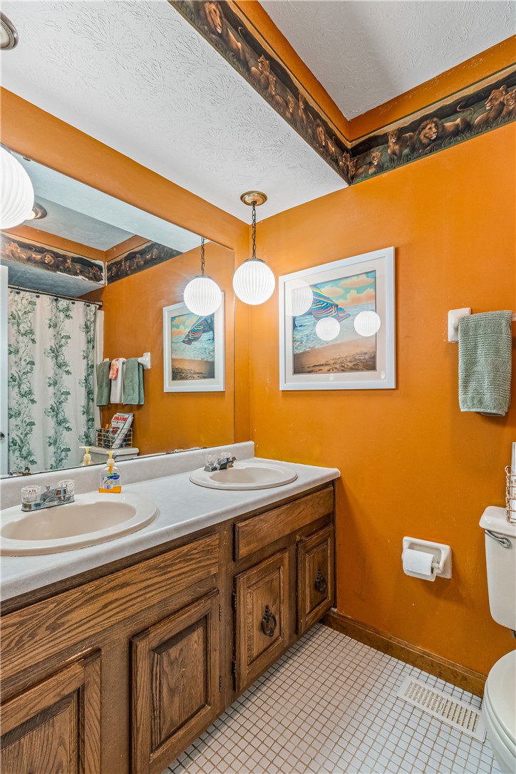 610 West Alex Bell Road Dayton, OH 45459 - Photo 14 of 36 This bathroom offers ample counter space with dual sinks and traditional cabinetry.