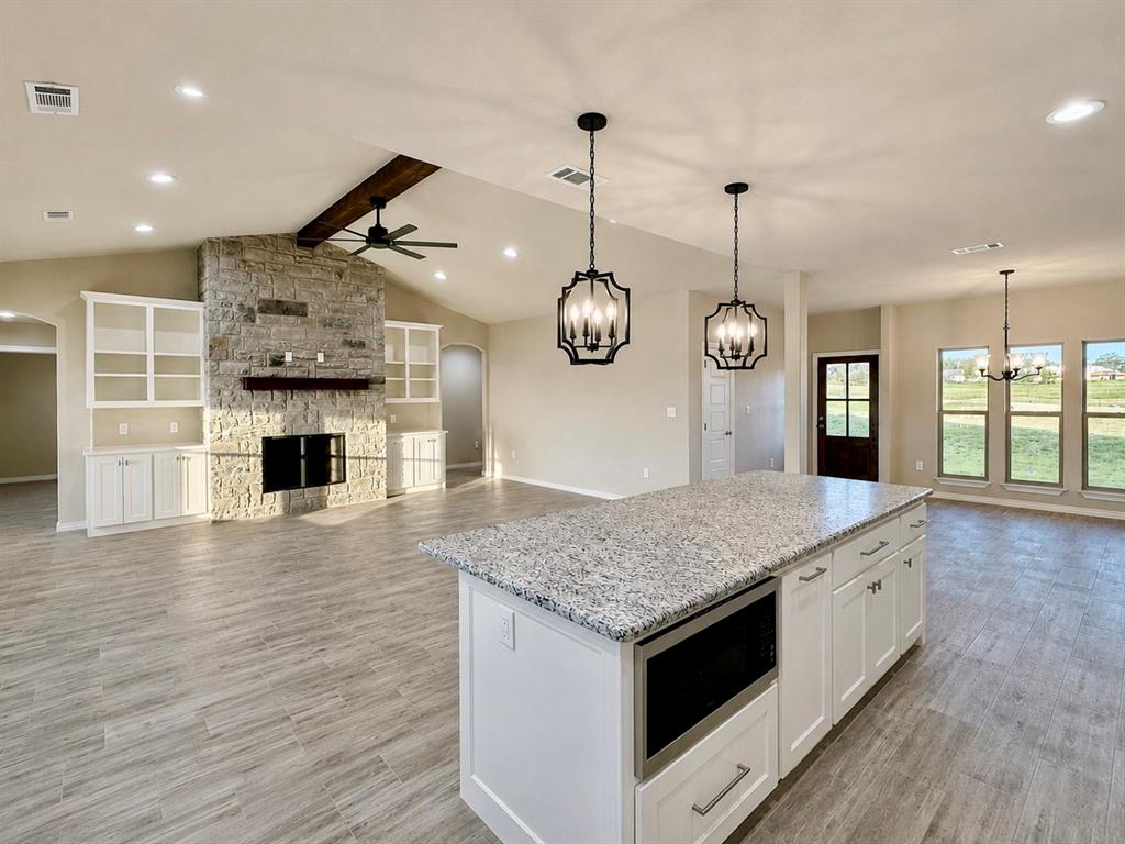 1013 Abbie Ruth Court Springtown, TX 76082 - Photo 6 of 30 Kitchen is open to the living room and dining space
