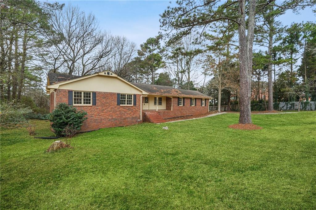 665 Arnold Road Lawrenceville, GA 30044 - Photo 14 of 38 a view of a house with backyard and garden