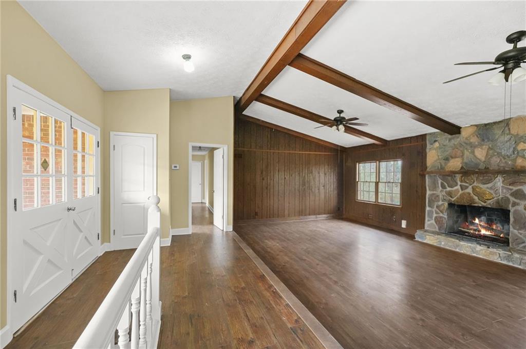 665 Arnold Road Lawrenceville, GA 30044 - Photo 20 of 38 a view of an empty room with wooden floor fireplace and a window
