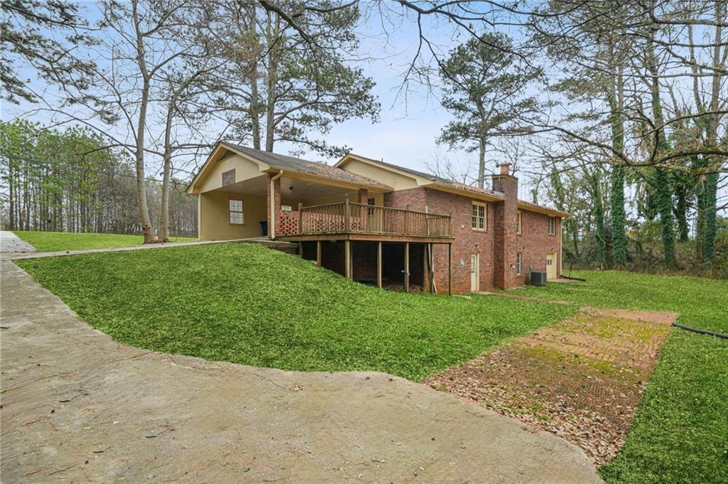 665 Arnold Road Lawrenceville, GA 30044 - Photo 30 of 38 a view of a big house with a big yard and large trees