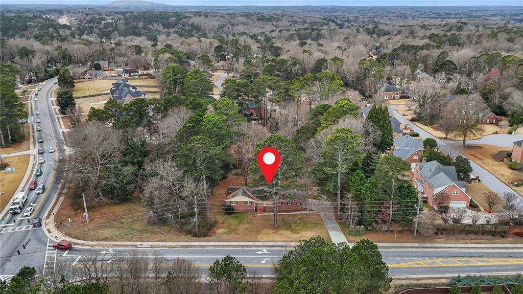 665 Arnold Road Lawrenceville, GA 30044 - Photo 8 of 38 an aerial view of a house with a yard and a large tree