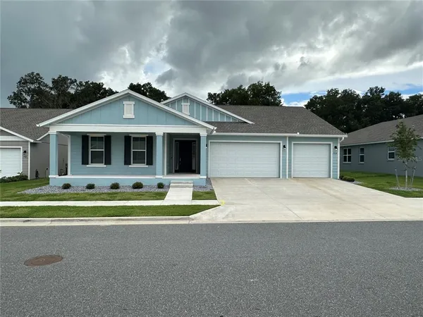 a front view of a house with a yard and porch