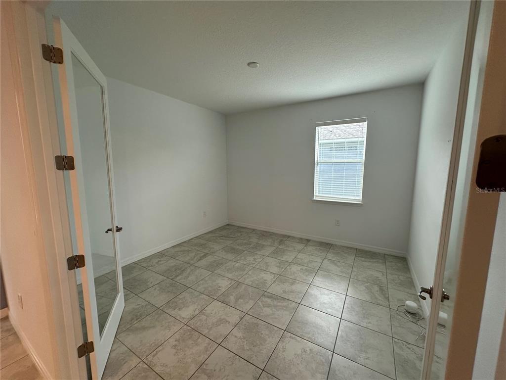 7526 Southwest 65th Place Road Ocala, FL 34474 - Photo 18 of 28 a view of an empty room with a window