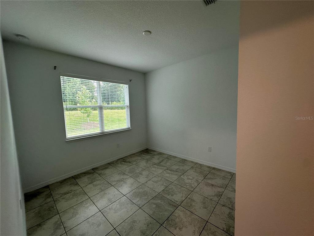 7526 Southwest 65th Place Road Ocala, FL 34474 - Photo 19 of 28 an empty room with windows