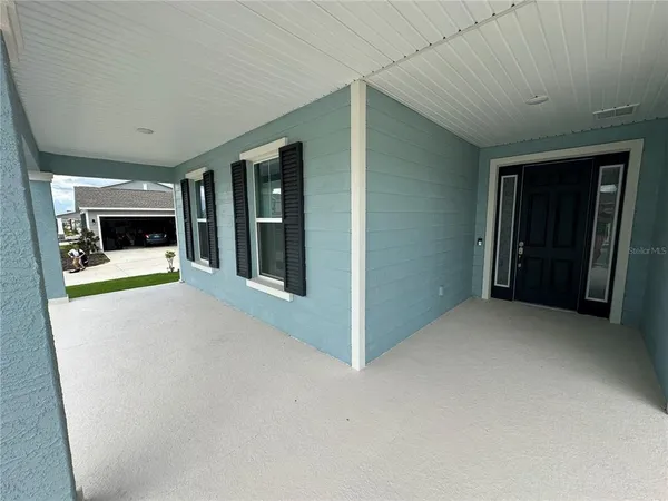 an empty room with fireplace and windows