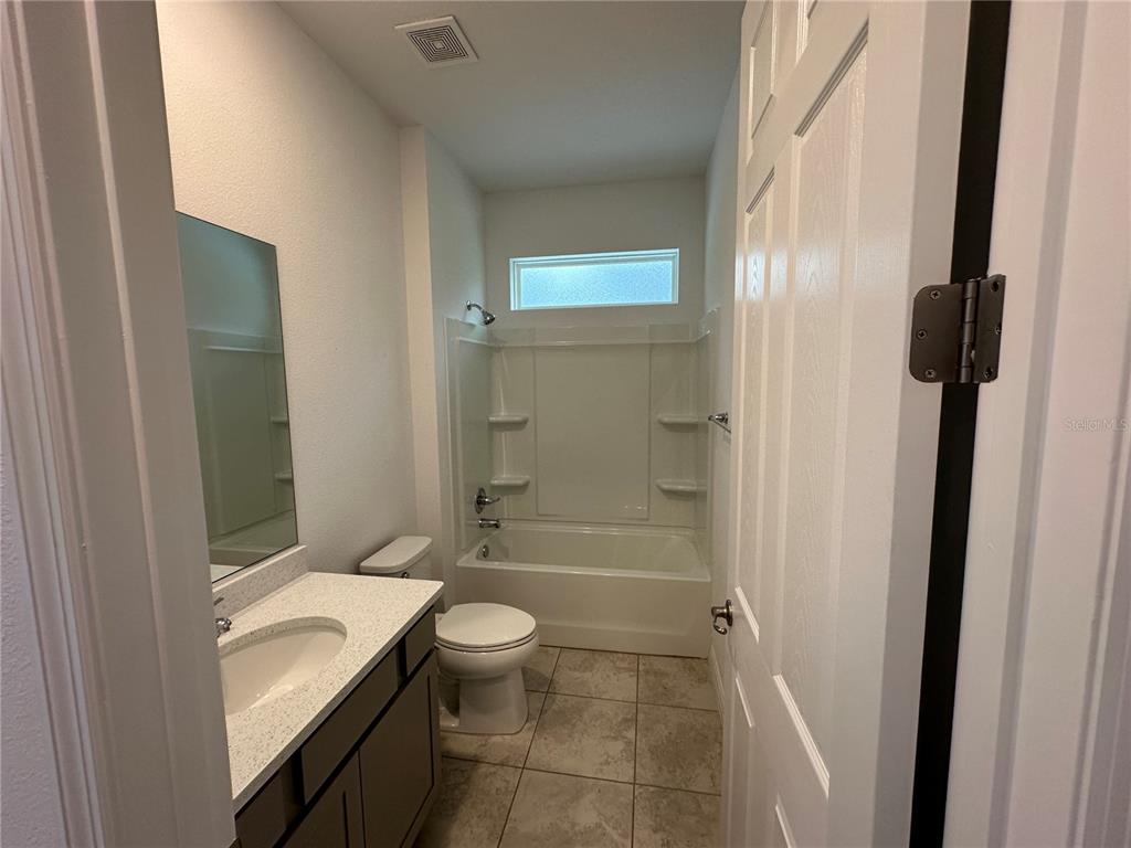 7526 Southwest 65th Place Road Ocala, FL 34474 - Photo 21 of 28 a bathroom with a sink a toilet and shower