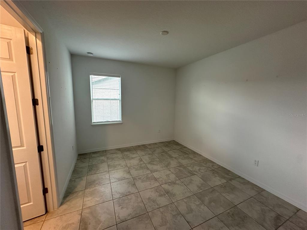 7526 Southwest 65th Place Road Ocala, FL 34474 - Photo 22 of 28 an empty room with windows