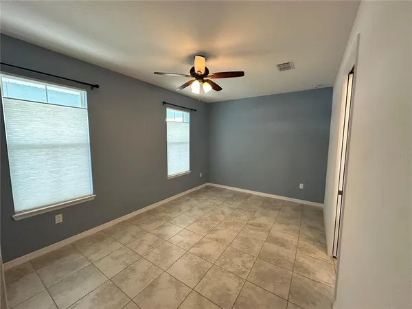 a bathroom with a granite countertop toilet and a shower