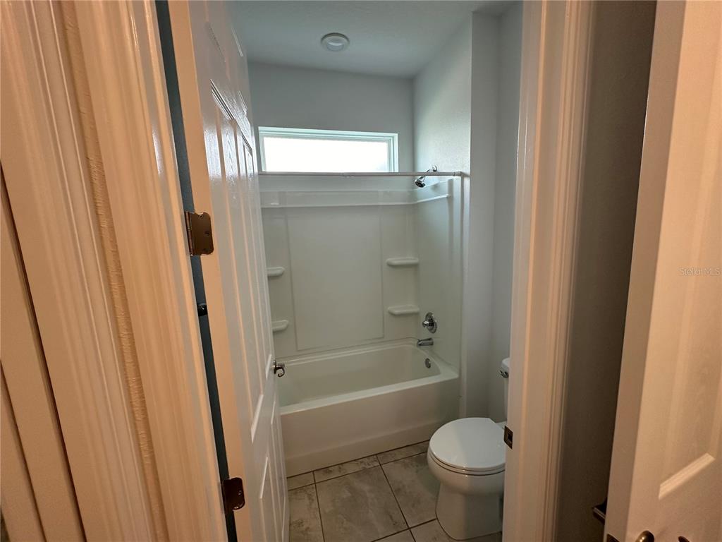 7526 Southwest 65th Place Road Ocala, FL 34474 - Photo 24 of 28 a bathroom with a granite countertop toilet and a shower