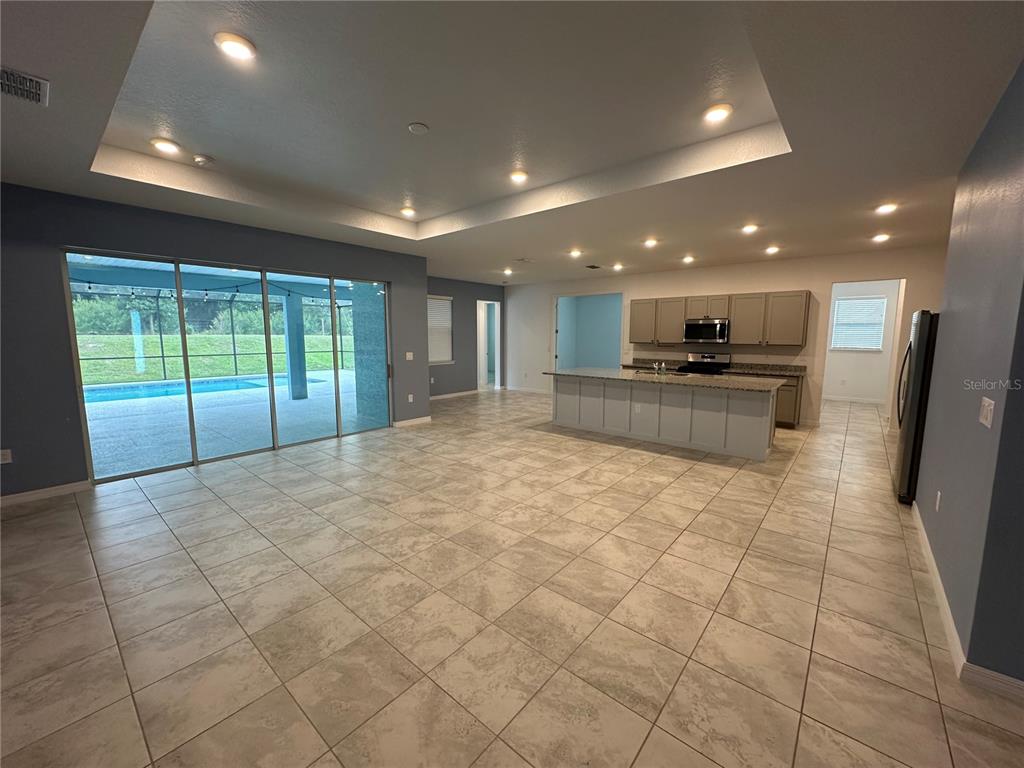 7526 Southwest 65th Place Road Ocala, FL 34474 - Photo 6 of 28 a large kitchen with stainless steel appliances granite countertop a large stove top oven and a glass door