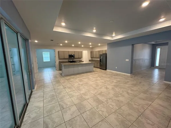 a large kitchen with kitchen island granite countertop a large counter top and white cabinets