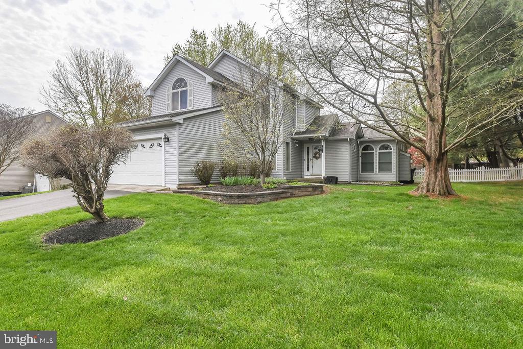 a front view of house with a garden