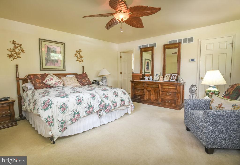 2 Battle Drive Newark, DE 19702 - Photo 22 of 35 a bedroom with a large bed and a chandelier