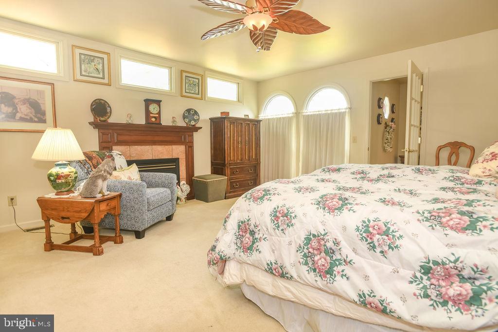 2 Battle Drive Newark, DE 19702 - Photo 24 of 35 a spacious bedroom with a bed and a chandelier
