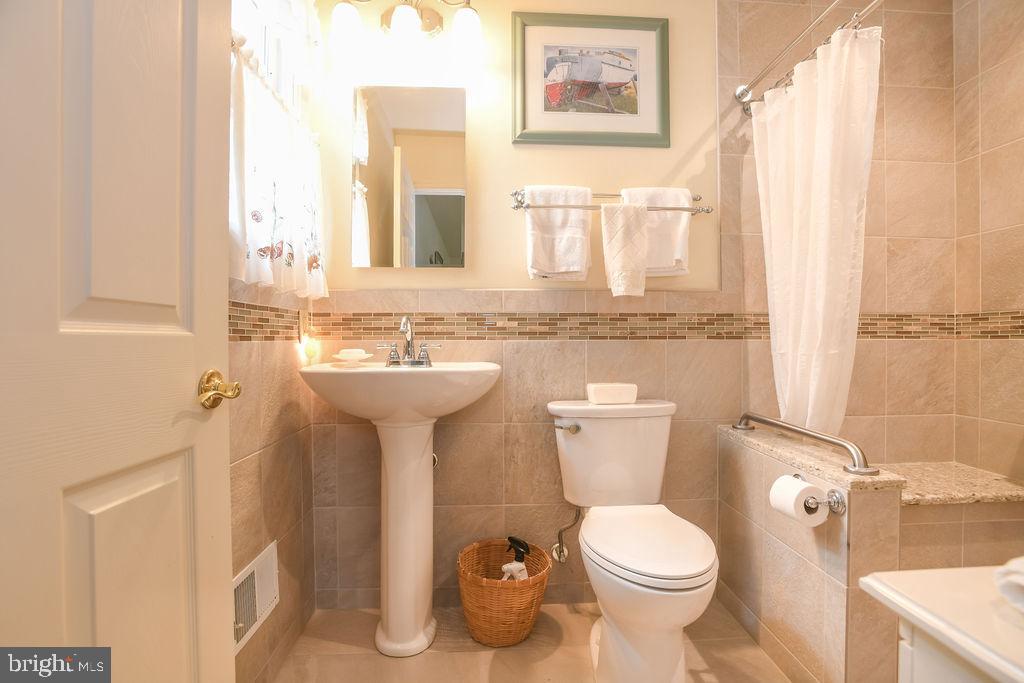 2 Battle Drive Newark, DE 19702 - Photo 25 of 35 a bathroom with a toilet sink and mirror