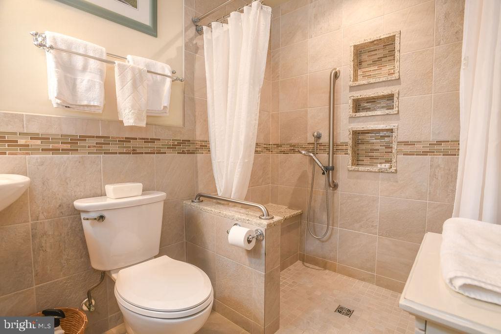 2 Battle Drive Newark, DE 19702 - Photo 26 of 35 a bathroom with a toilet a sink and a shower