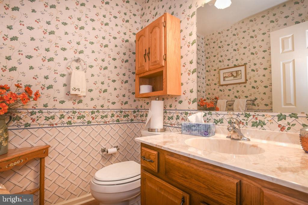 2 Battle Drive Newark, DE 19702 - Photo 33 of 35 a bathroom with a granite countertop toilet sink and mirror