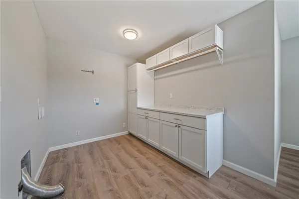 an empty room with wooden floor and closet