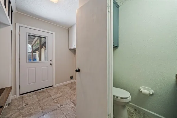 a view of kitchen with refrigerator and window